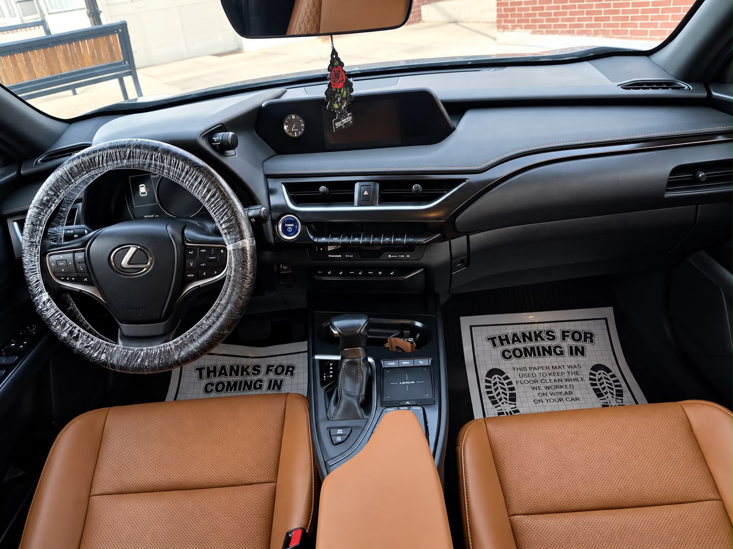 Lexus interior with warm leather seats and a freshly detailed dashboard